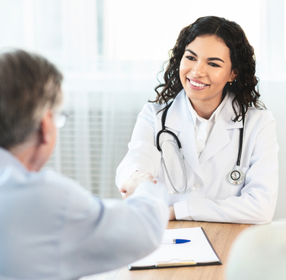 Doctor shaking a patient's hand over a desk