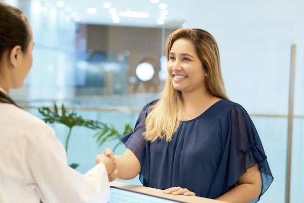 A physician greets a recruited patient who arrives for their first visit in a clinical trial for drug development