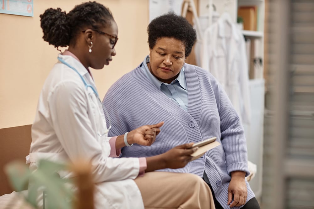A doctor and patient view information on a tablet